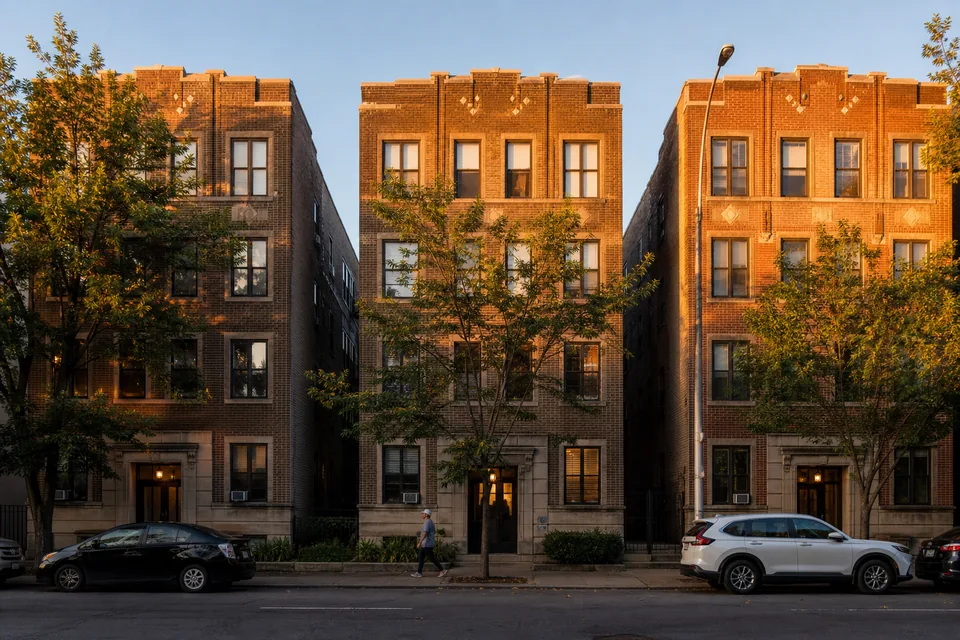 Row of mid-rise apartment buildings on a US street at golden hour